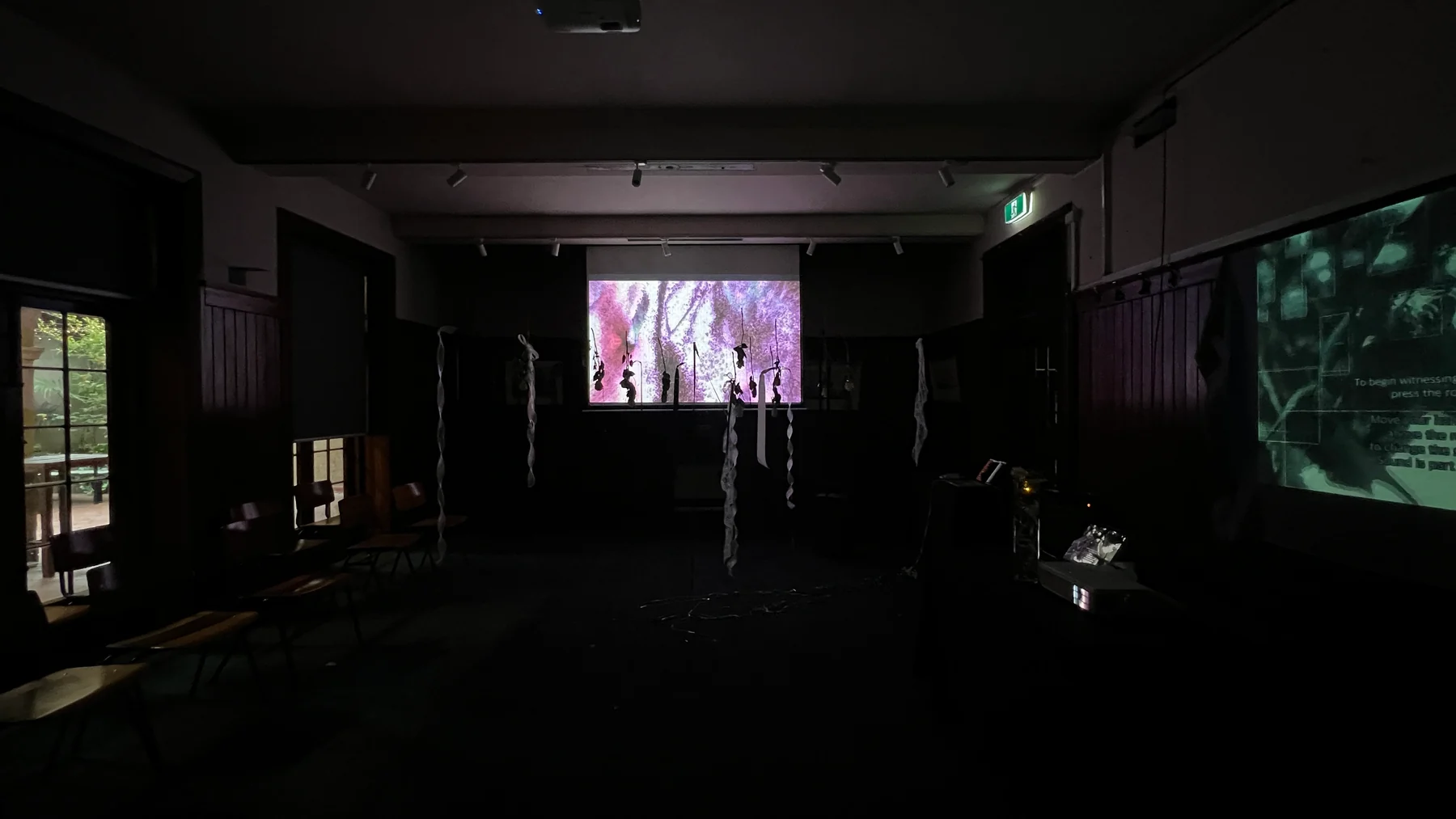 Melbourne installation view with hanging roses and projected images, October 2026.